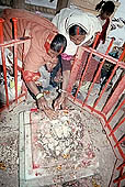 Varanasi - Pilgrims worship at the footprint of Vishnu close the embankment of Manikarnika ghat